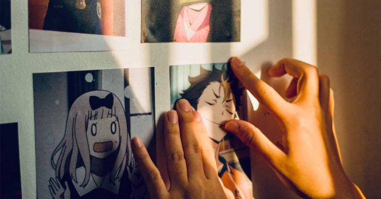 Someone looking at different styles of art on a wall