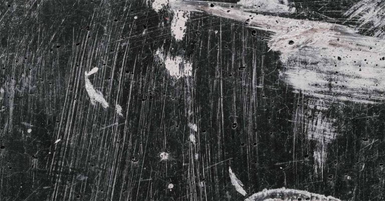 A black surface with scratch marks on it