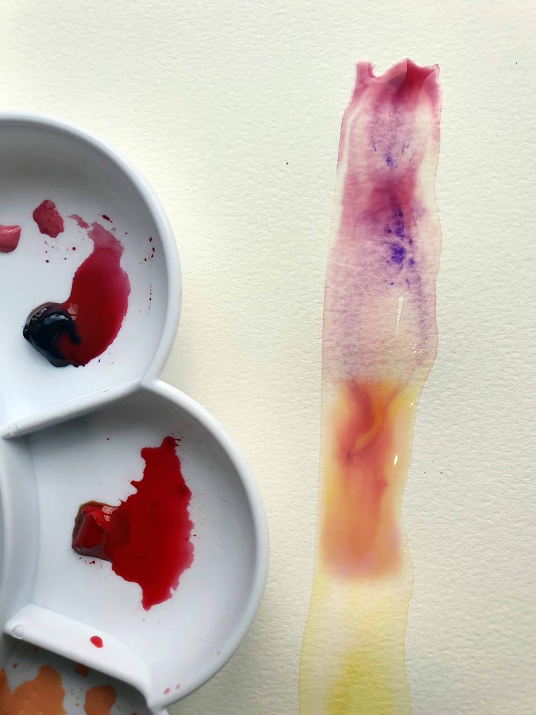 watercolor paint palette and a close up of red and purple watercolor paint