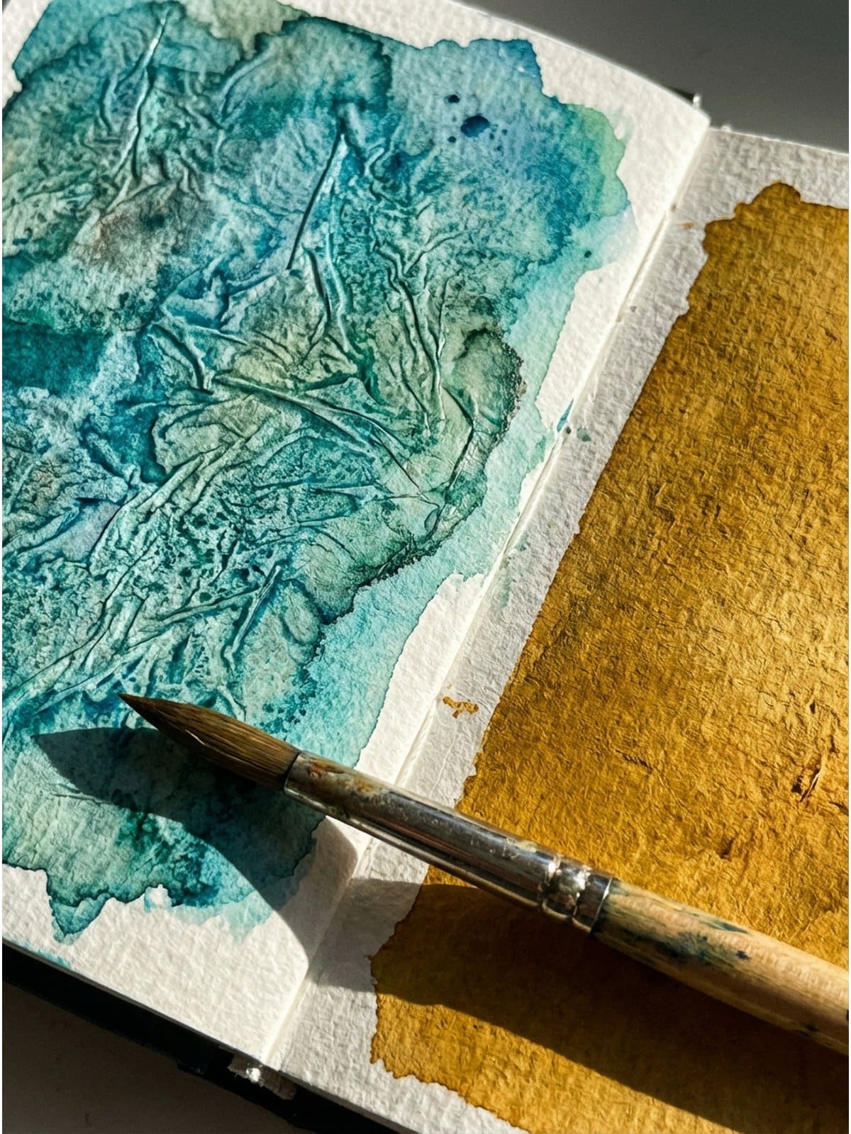 Plastic wrap watercolor technique creating marbled textures