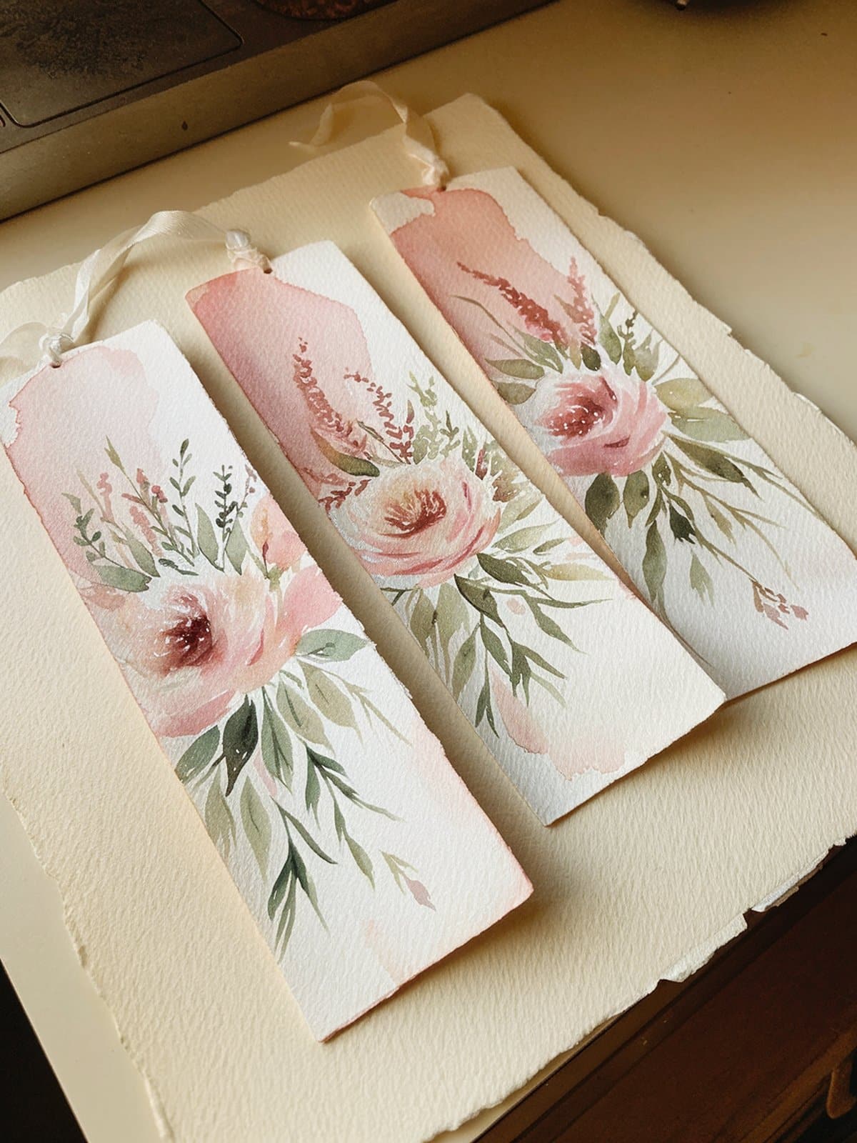 Watercolor bookmark supplies including paints, brushes, and watercolor paper