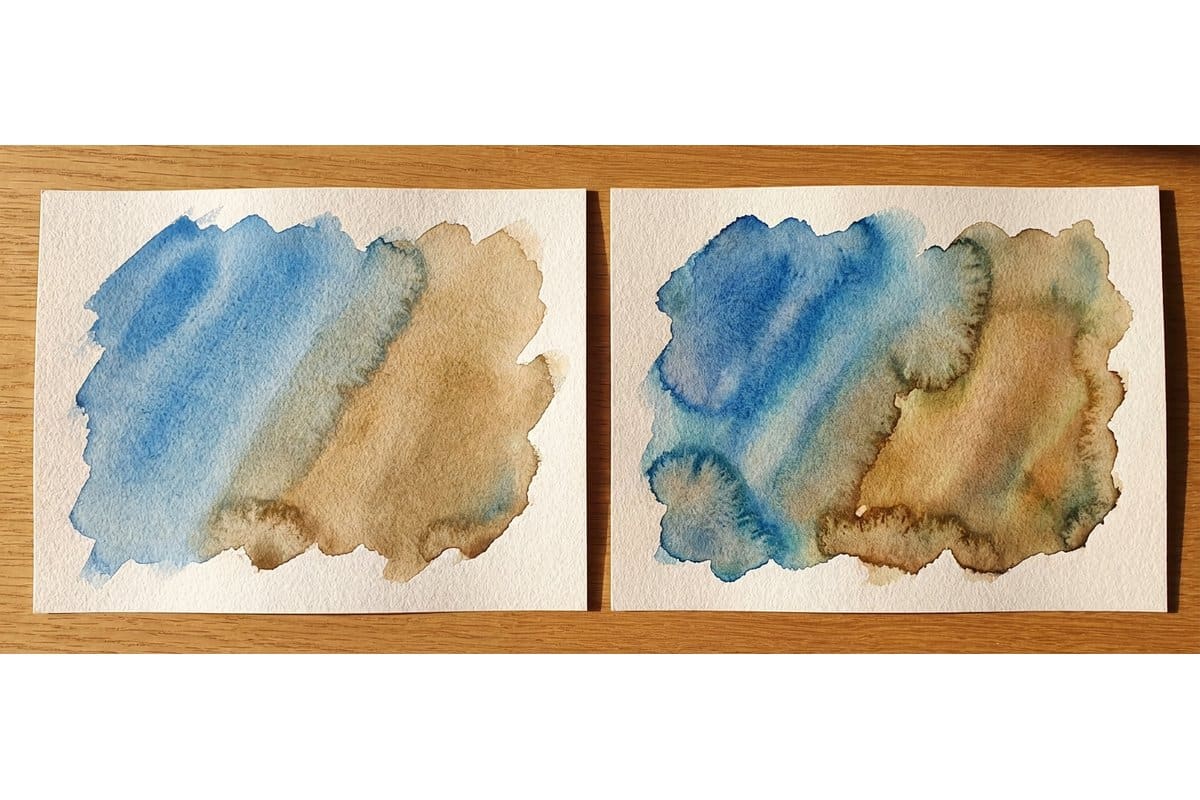 Flat lay of budget watercolor paper pads including Canson XL and Winsor Newton Cotman with paint swatches