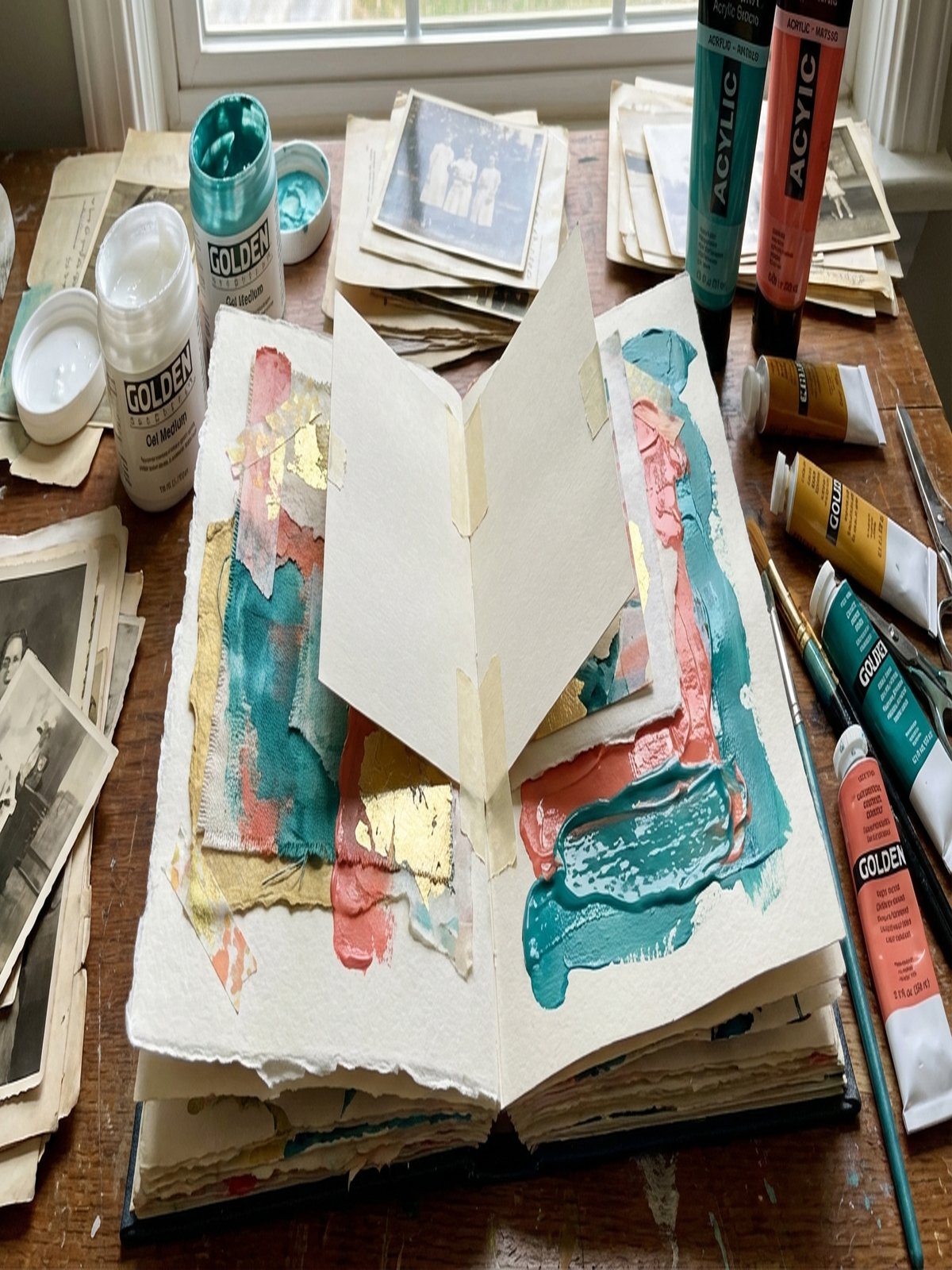 Mixed media sketchbook spread with layered collage elements and lift-able paper layers