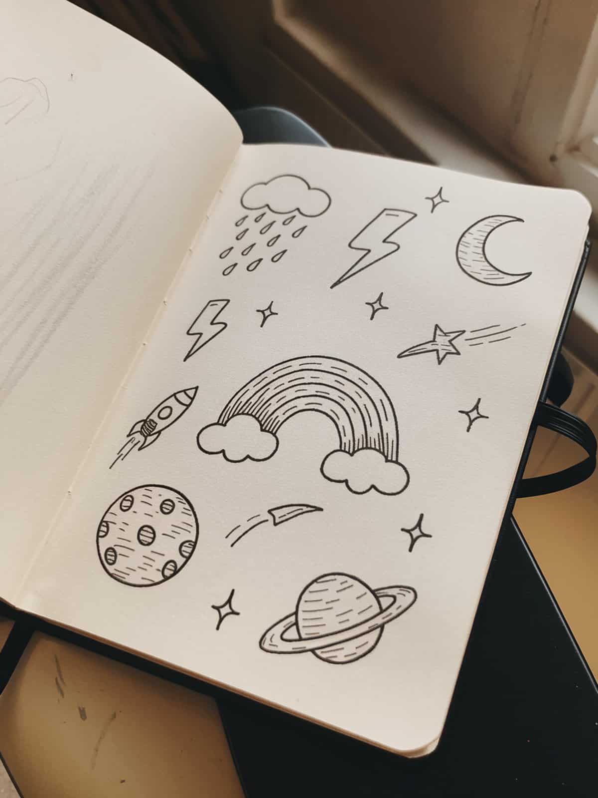 Simple weather and space doodles including sun moon stars clouds rainbow and planets