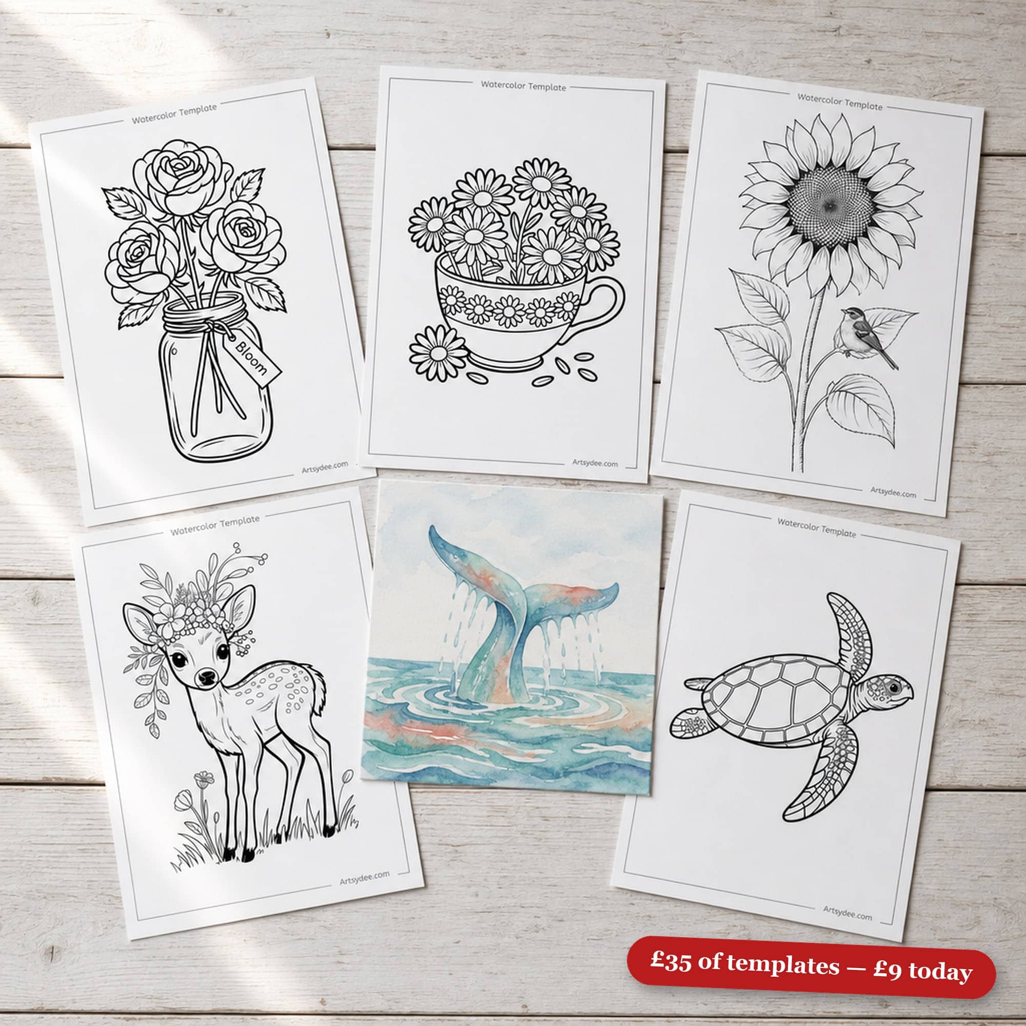 Watercolor Starter Vault &mdash; the real printed templates from the vault on a white-washed desk: roses in a mason jar, daisies in a teacup, a sunflower with a bird, a fawn, a sea turtle, and the painted whale example