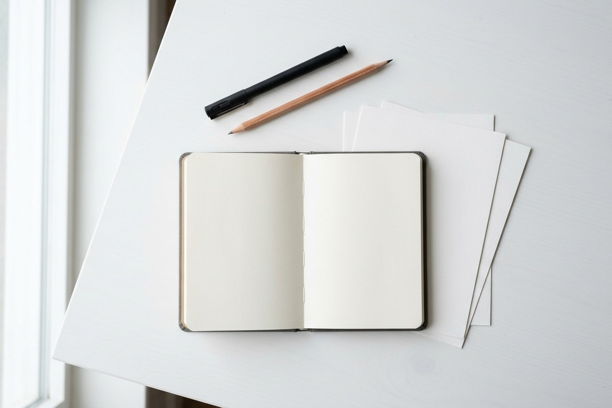 Simple doodling supplies flat lay with fineliner pen and sketchbook