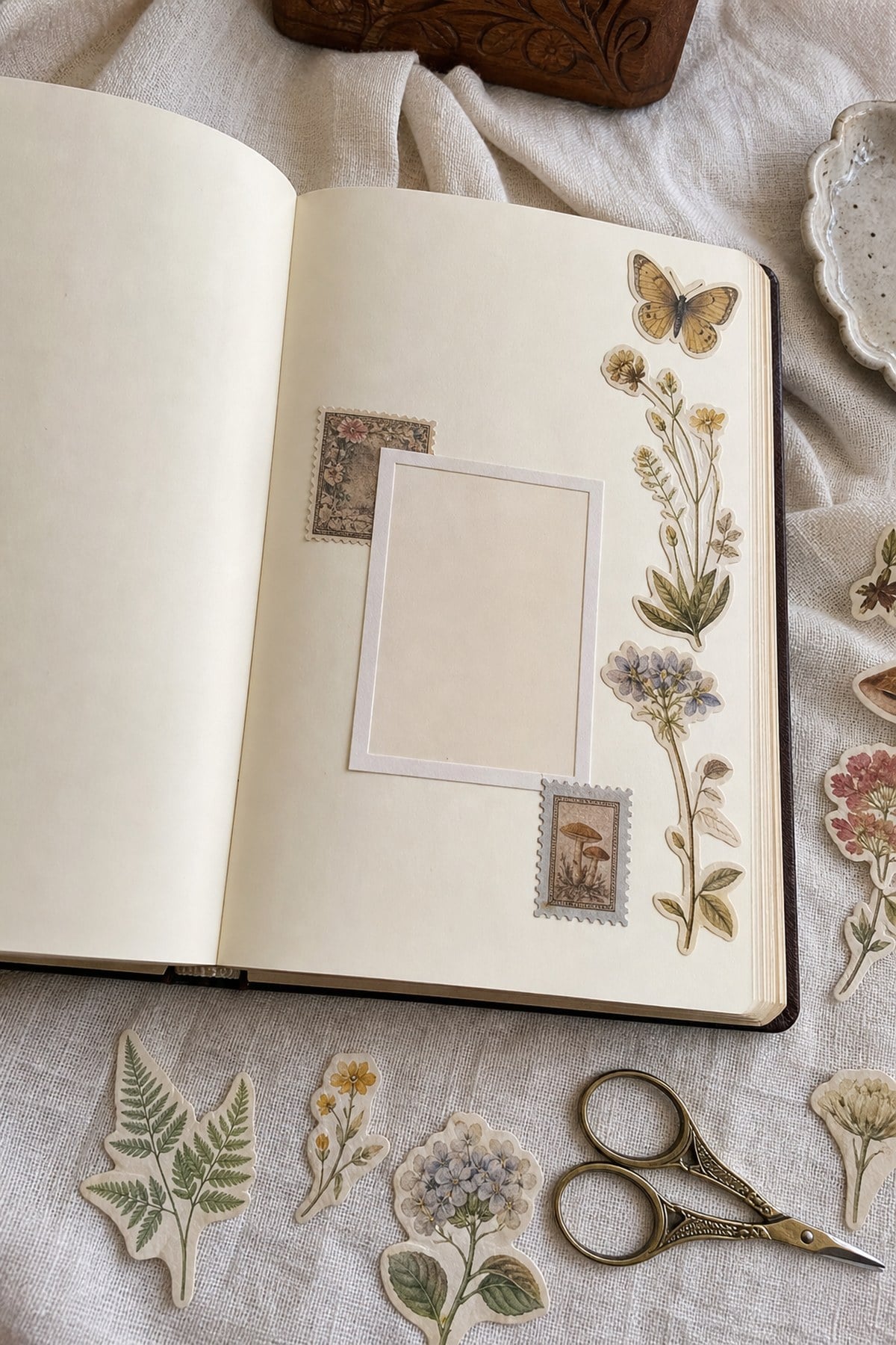 An open journal decorated with cut-out vintage stickers along the page edge and around a photo