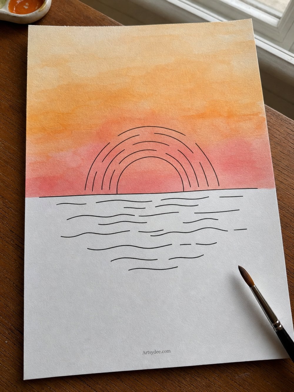 A watercolour sunset part-way through, sky washed in warm orange and pink