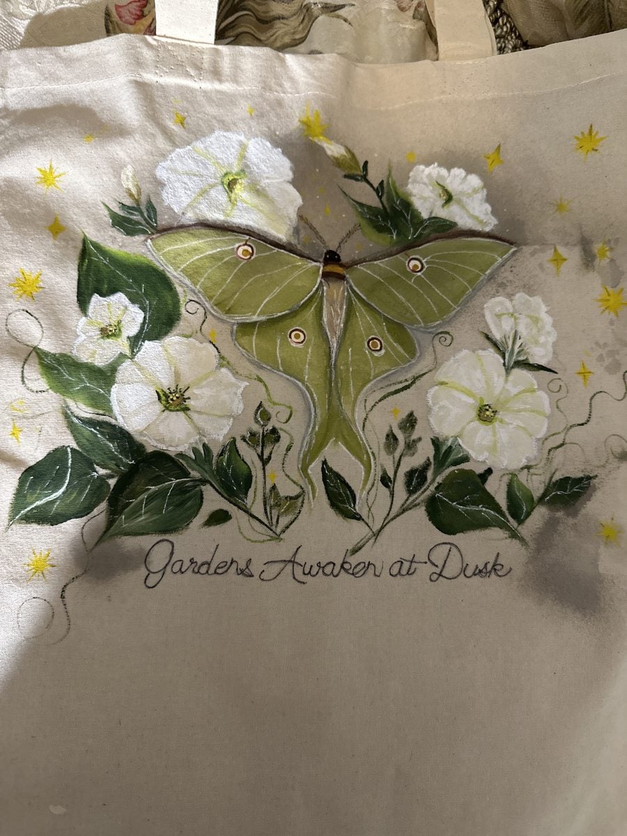 Hand-painted canvas tote bag with a luna moth design, Gardens Awaken at Dusk, by reader Diane N.
