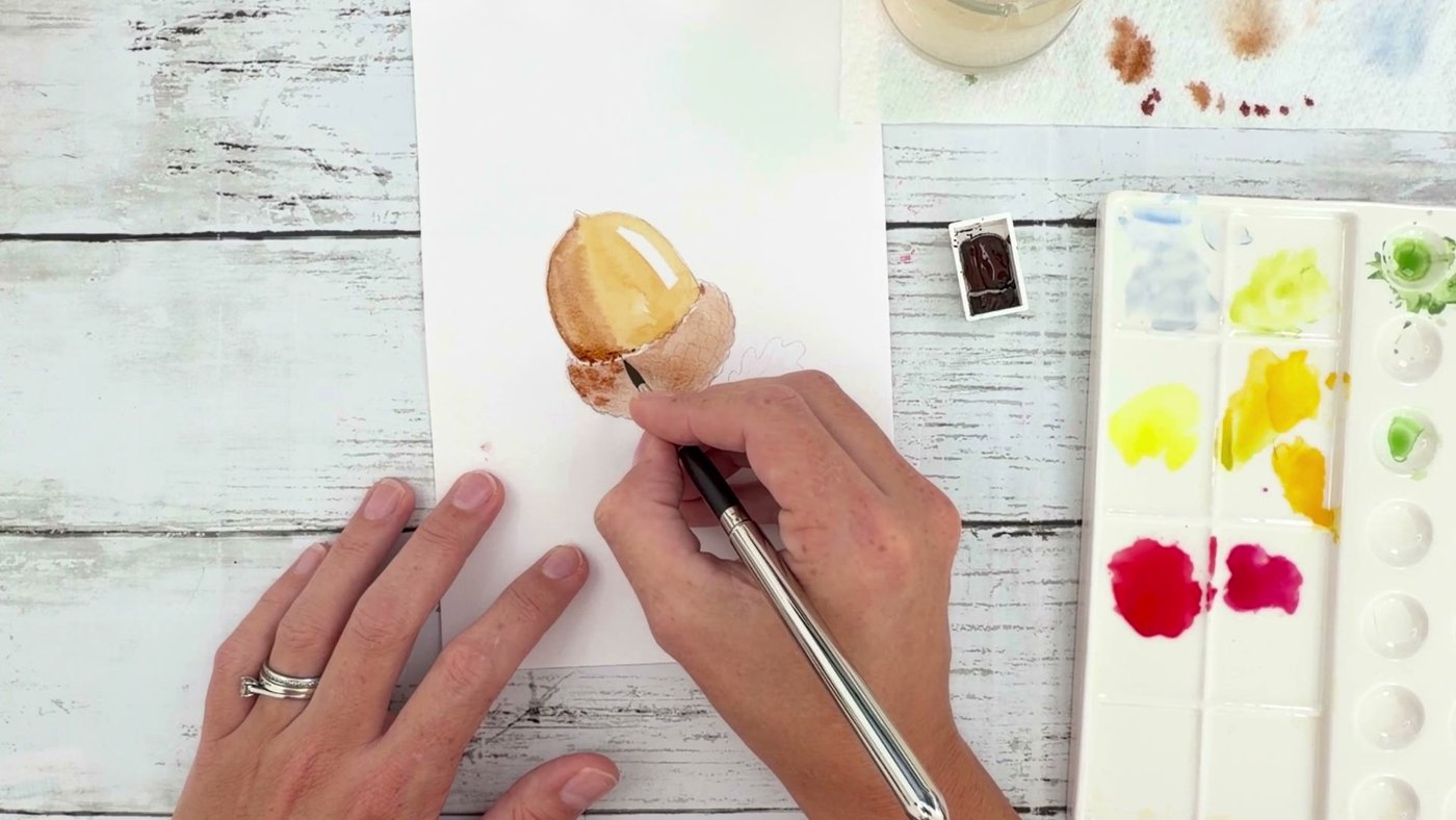 Dabbing stronger burnt umber onto the acorn cup to paint its little scales