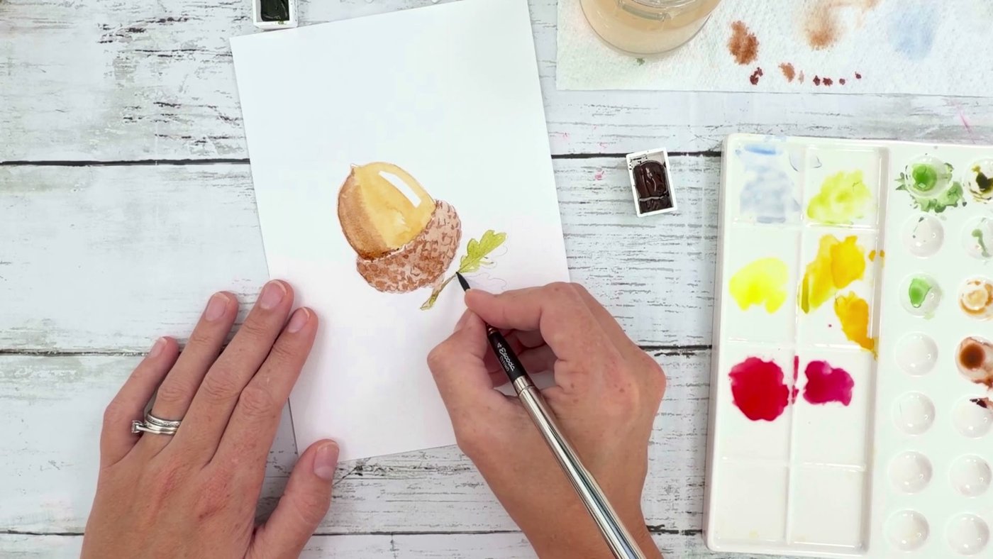 Painting the small oak leaves and stem in olive green