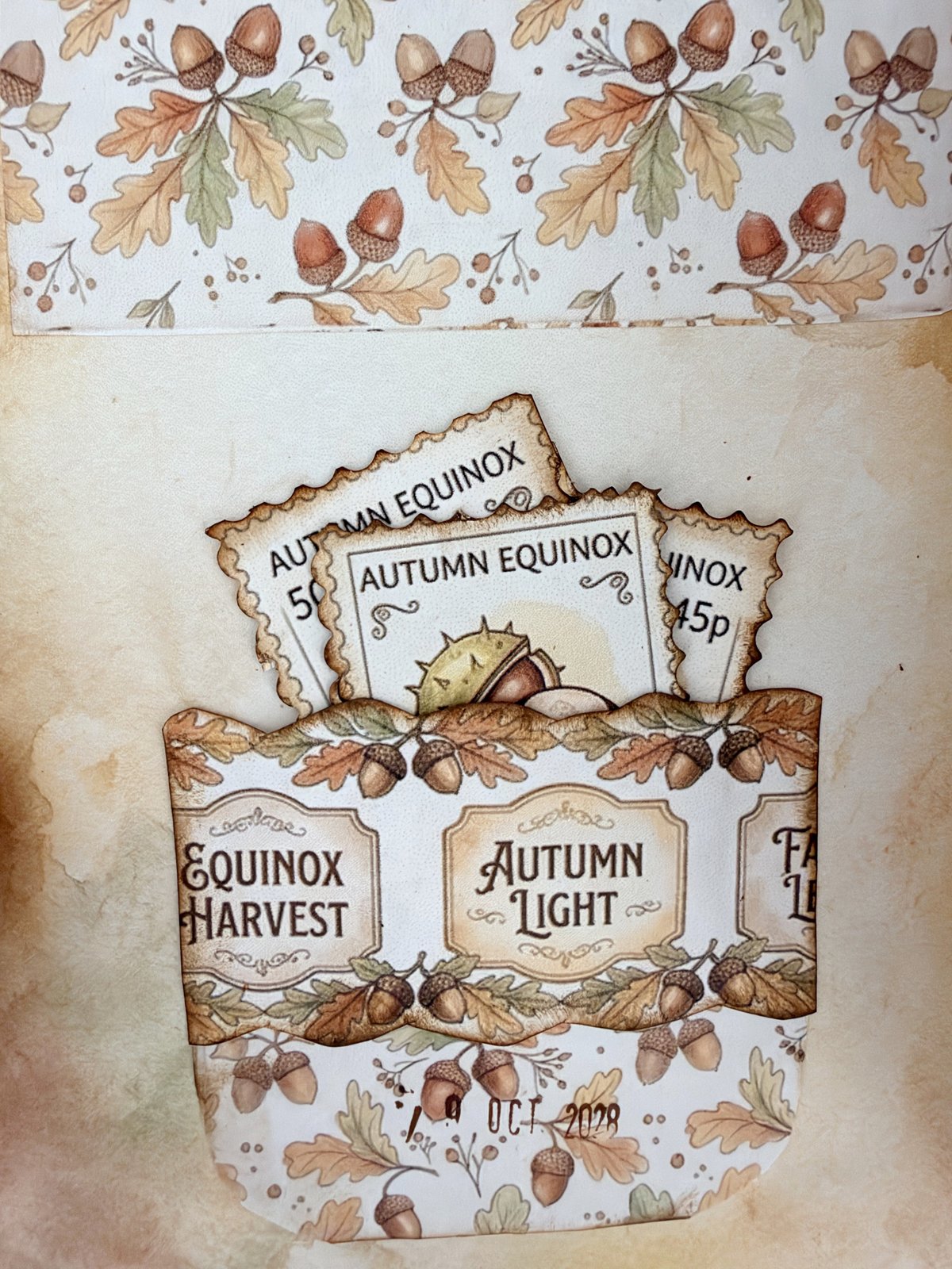 Curved paper pocket on an acorn page holding autumn postage-stamp cut-outs