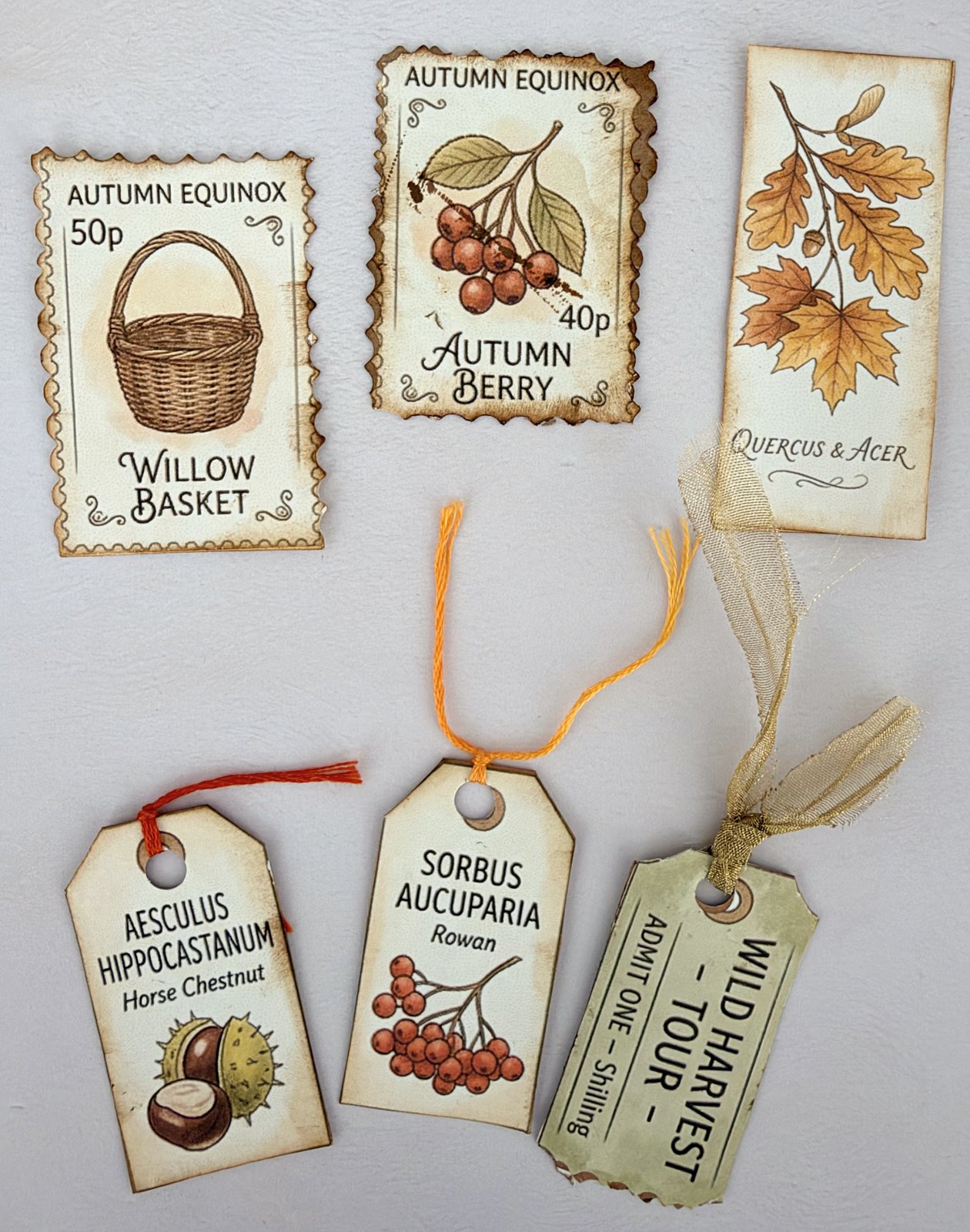 Small vintage-style junk journal tags, tickets and postage-stamp cut-outs with ribbon ties