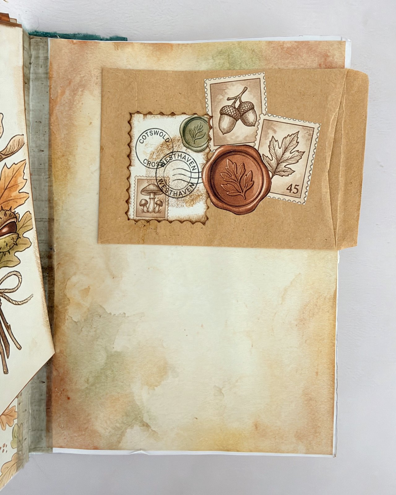 Kraft paper envelope on a journal page decorated with acorn postage stamps and a wax seal