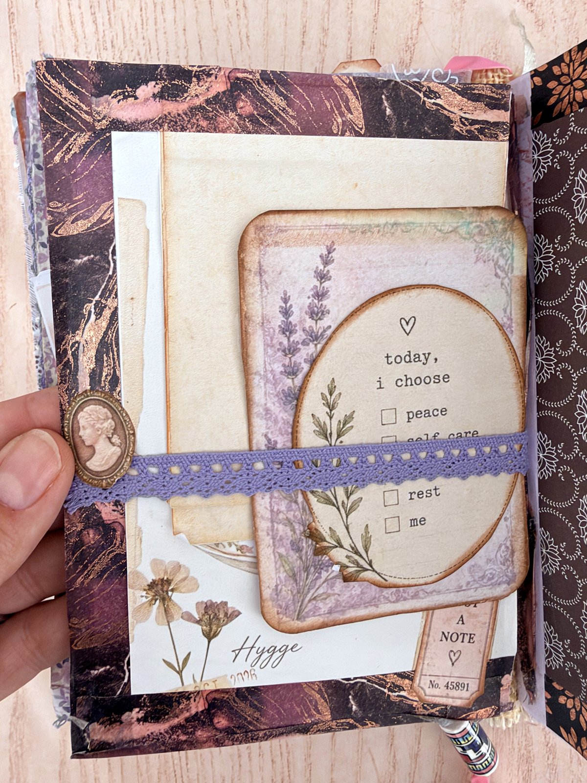 Purple lace belly band holding a lavender journaling card in a junk journal