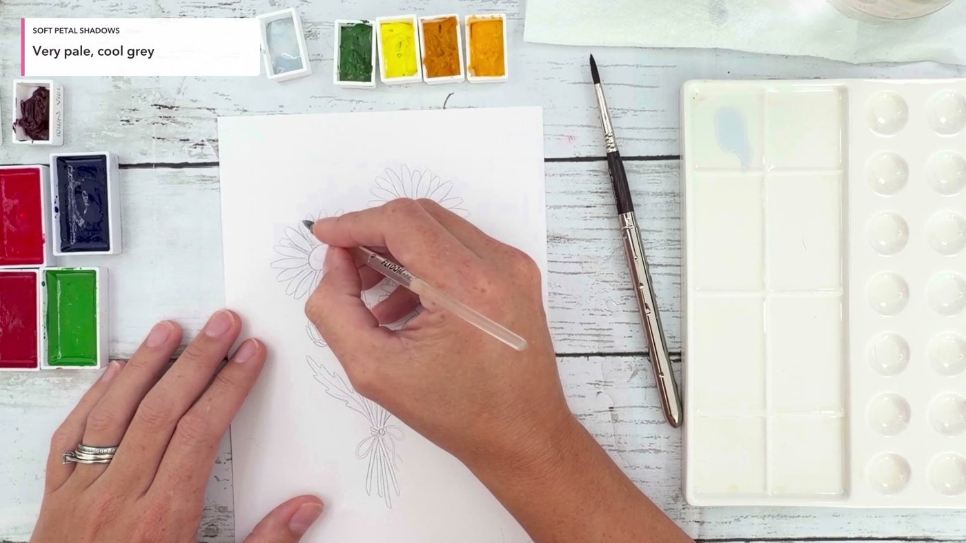 Painting a very pale cool grey shadow onto the daisy petals while leaving the paper white