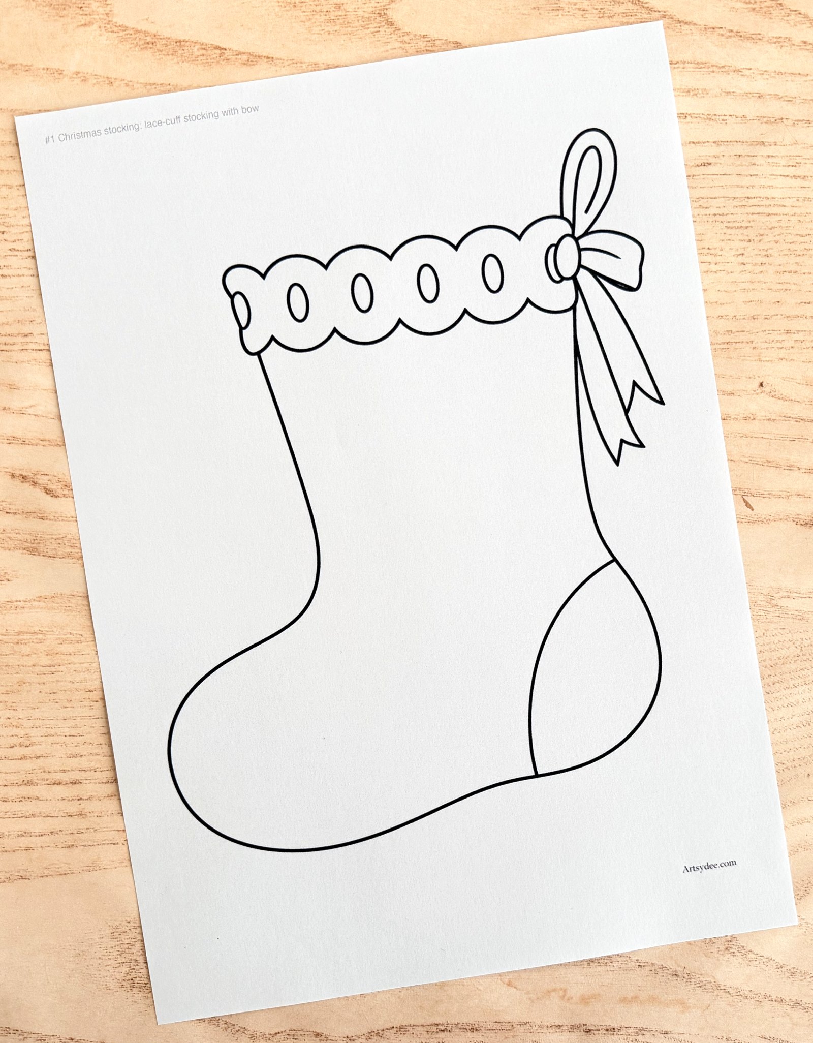 The free Christmas Stocking Templates printed on paper and photographed on Dee's desk at Artsydee