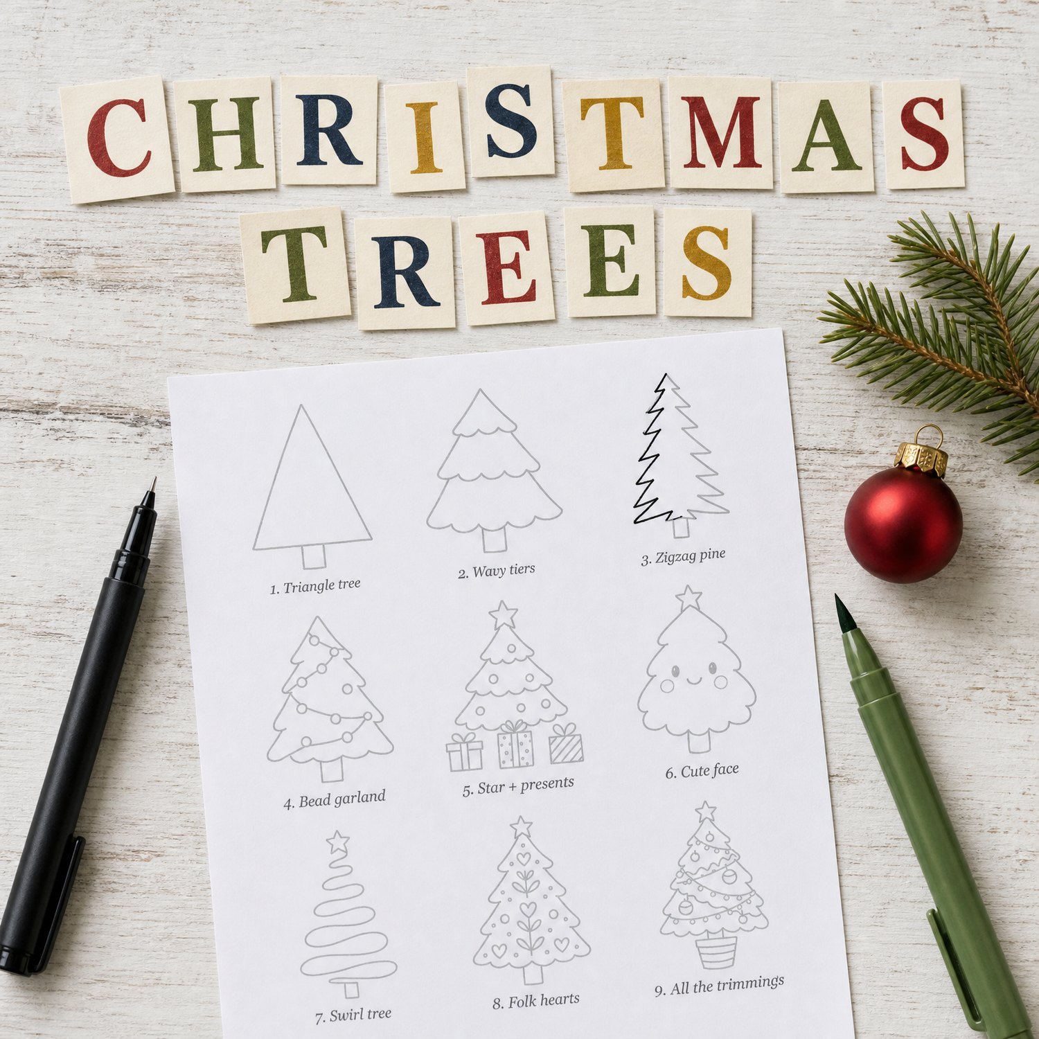 A printed page of nine Christmas tree drawings to trace, with a fineliner, a green brush pen, a fir sprig and a red bauble, under cut-paper letters spelling Christmas Trees