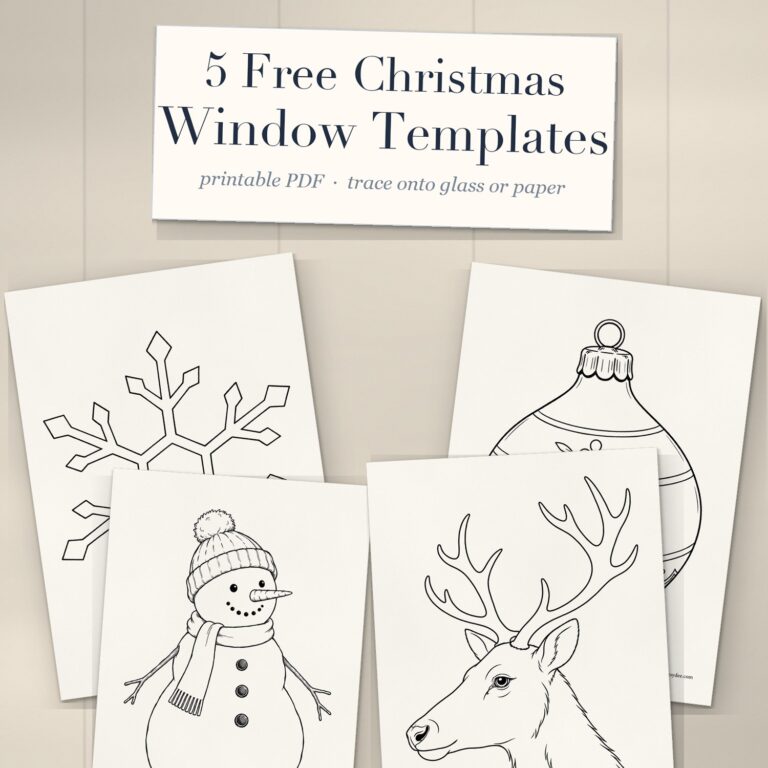 Printed Christmas window drawing templates of a snowflake, bauble, snowman and reindeer head on a desk under a cream title card reading 5 Free Christmas Window Templates