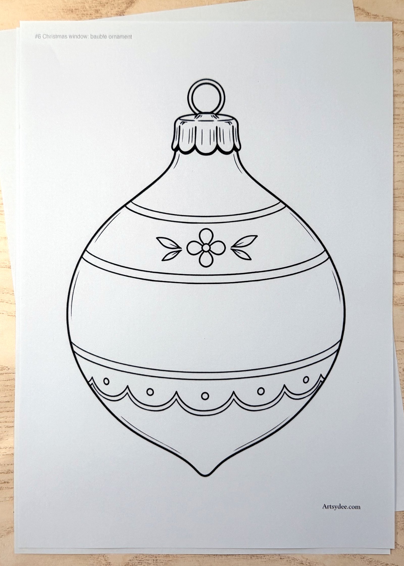 The free Christmas Window Drawing Templates printed on paper and photographed on Dee's desk at Artsydee