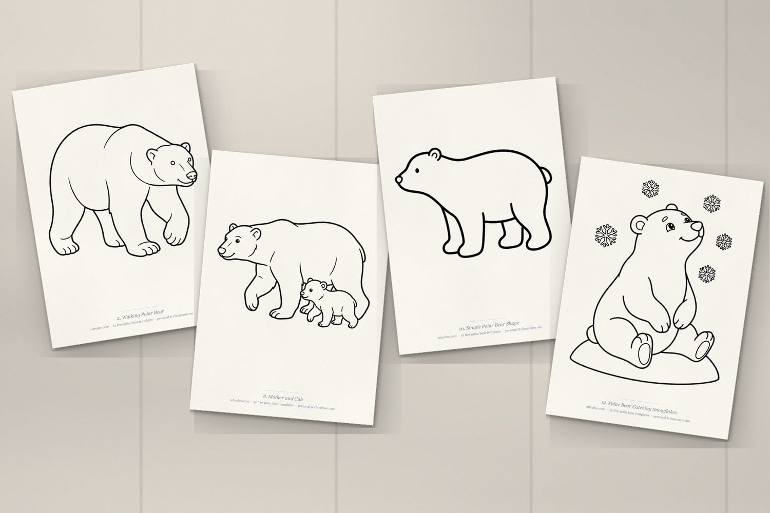 Four printed polar bear templates on a desk: walking polar bear, mother and cub, simple polar bear shape and polar bear catching snowflakes
