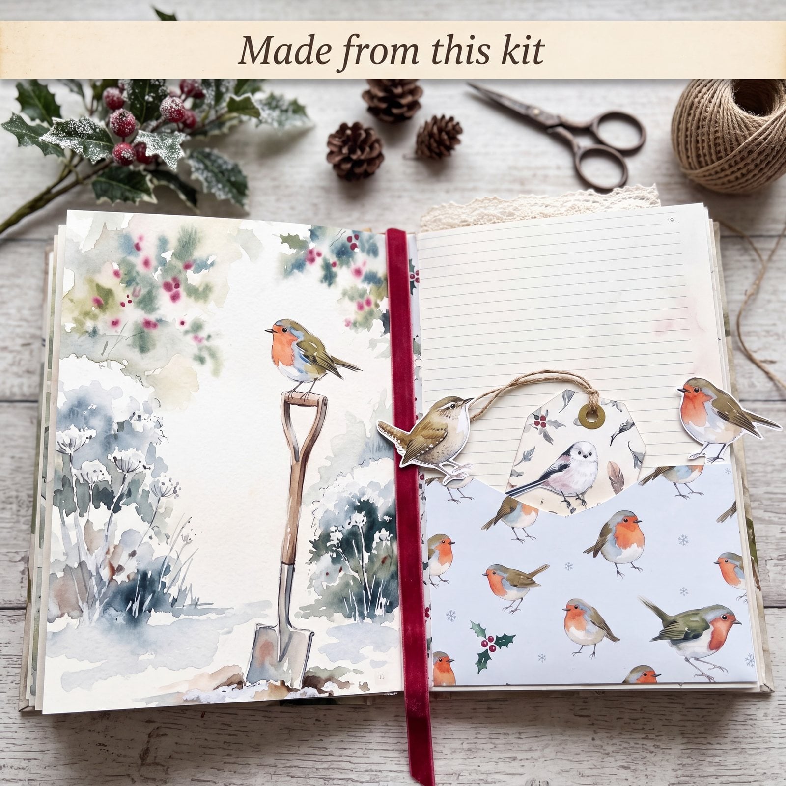 An open robin junk journal with a snowy garden spade scene and a robin-patterned pocket